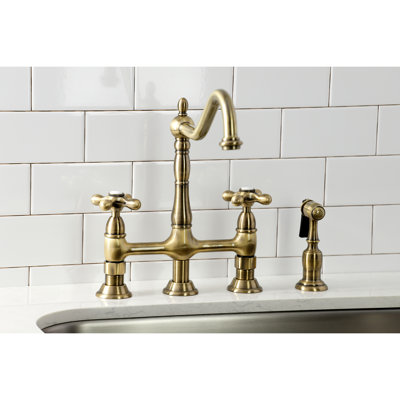 Kingston Brass Heritage Two-Handle 4-Hole Deck Mount Bridge Kitchen Faucet with Brass Side Sprayer