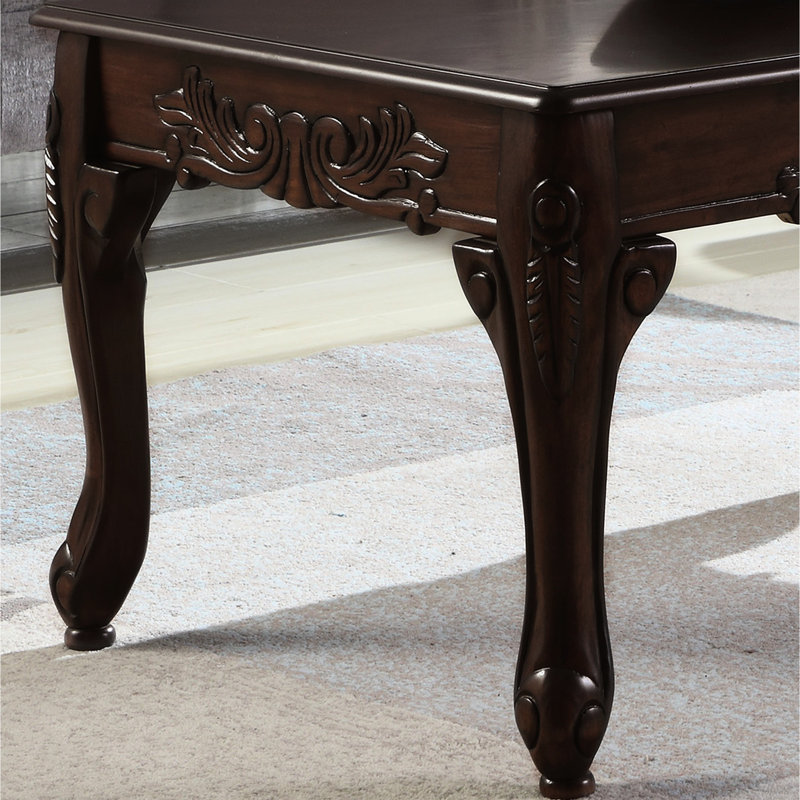 Warm Colored Dark Cherry Wood Coffee Table With Ornate Carvings Decor