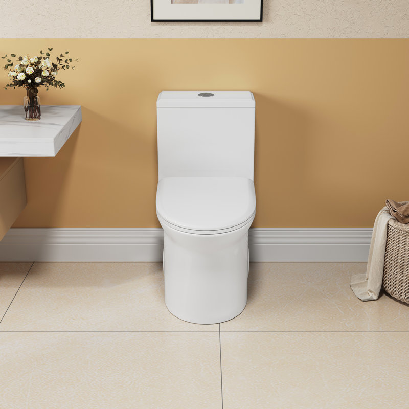Une toilette en céramique, chasse d'eau 1,1 / 1,6, hauteur de confort de 15,55 po, siège à fermeture douce blanc et
