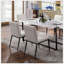 Chaises d'appoint en similicuir ivoire avec structure en métal noir, siège rembourré et design contemporain pour une salle à manger élégante