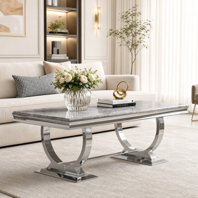 Table basse grise et argentée avec base en métal poli en forme de U