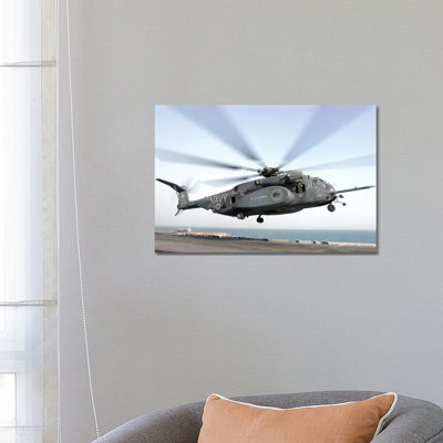 A CH-53 Sea Stallion Helicopter Leaves The Flight Deck Of USS Kearsarge by Stocktrek Images - Wrapped Canvas Print