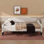 A Full-Size Upholstered Daybed With Tufted Detailing