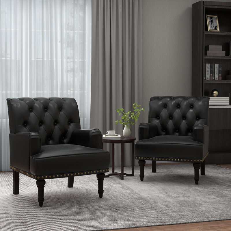 Fauteuil rembourrÃ© Enoks en simili cuir, capitonnÃ© et ornÃ© de clous dÃ©coratifs, Similicuir noir