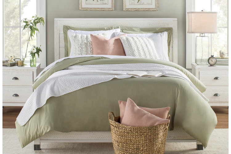 sage green bedroom with pink pillows