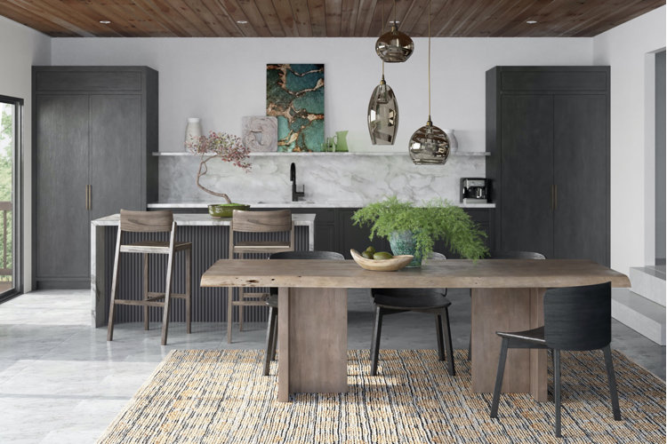 Modern kitchen with a white marble backsplash, black cabinetry, and a wood dining table.
