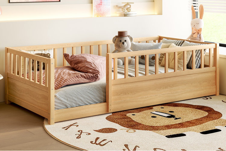 natural wood montessori bed with slatted guardrails in toddler bedroom