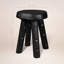 Tabouret Totem Ebonized (grand) ~ Inspiré par sa présence sculpturale calcinée, ce tabouret 100% récupéré incarne à la fois le savoir-faire artisanal et le minimalisme moderne, comme une relique renaissante en ébène.