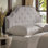Tête de lit pour grand lit en tissu gris clair - structure en bois massif et pieds en métal, hauteur réglable avec garniture cloutée