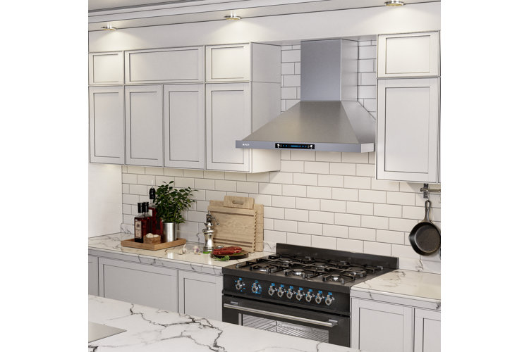Kitchen with white cabinets, subway tile backsplash, and recessed lights.