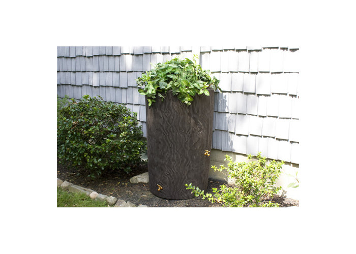 outdoor plastic rain barrel with plant on top