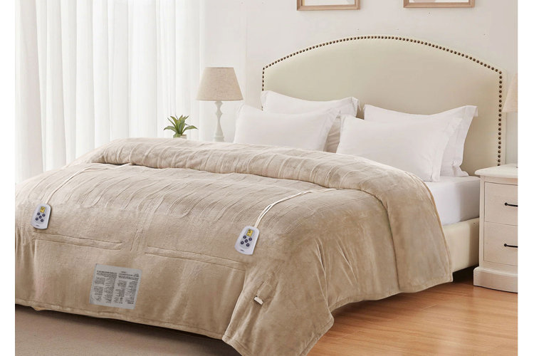 queen bed with a beige heated blanket on it