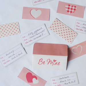 Bird eye view of home-printed date night cards filled out with hand-written date night ideas