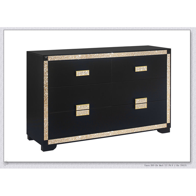Commode noire et dorée avec détails scintillants, tiroirs spacieux et poignées de bar épais pour un rangement élégant