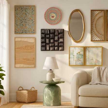 Gallery wall with decorative art, mirror, side table, lamp, and sofa.