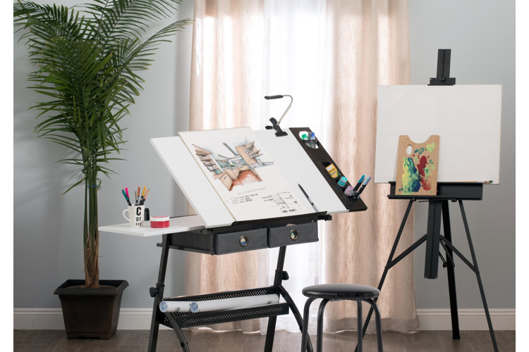 drafting desk in a home office displaying interior design plans