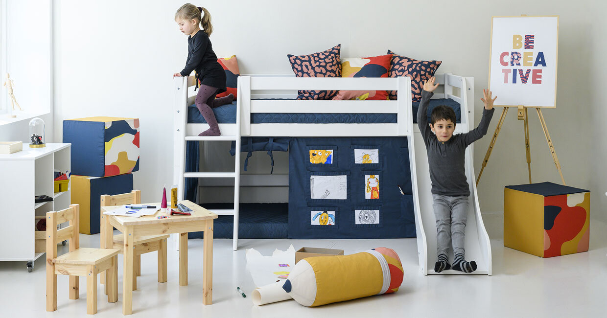 Hoppekids zeigt ein PREMIUM Halbhohes Bett mit Rutsche. Davor spielt ein junges Mädchen