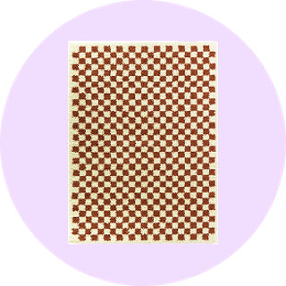 Brown and cream checkered rug on lilac background