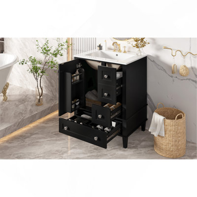 Ce meuble-lavabo noir de 24 pouces avec lavabo en céramique intégré comprend une tablette à double couche, des tiroirs à fermeture en douceur et une porte d'armoire à fermeture en douceur.