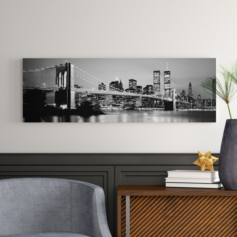 Illuminated Brooklyn Bridge With Lower Manhattan's Financial District Skyline In The Background In B&W, New York City, New York by Panoramic Images - Wrapped Canvas Panoramic Print