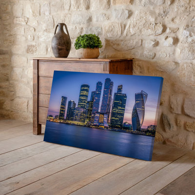 Canvas A Panoramic View Of A Modern Skyline At Dusk Showcasing Wall Art A Cluster Of Sleek Skyscrapers With Reflective Glass Facades Canvas Wall Art