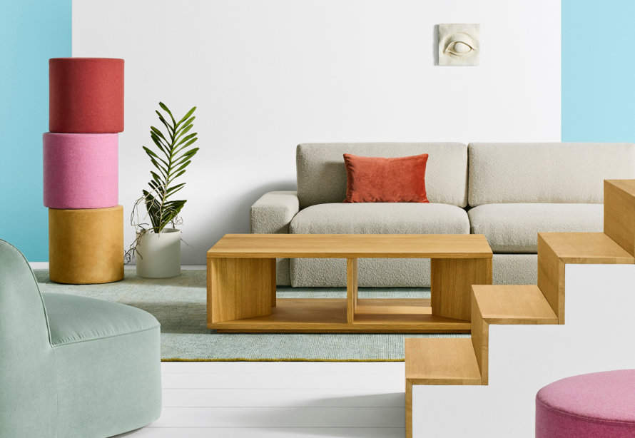 Contemporary living room with a beige couch, modern coffee table, and colorful accents.