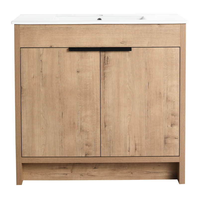 Meuble-lavabo de 36 po avec lavabo en céramique et portes à fermeture en douceur. Armoire moderne en contreplaqué en chêne imitation. Tablette réglable pour plus de rangement. Lavabo blanc facile à entretenir. Charnières silencieuses à 2 portes. Chêne