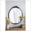 Miroir de conception classique avec forme ronde et cadre d'inspiration baroque pour la salle de bain, console de vestibule posée contre le mur-863140381