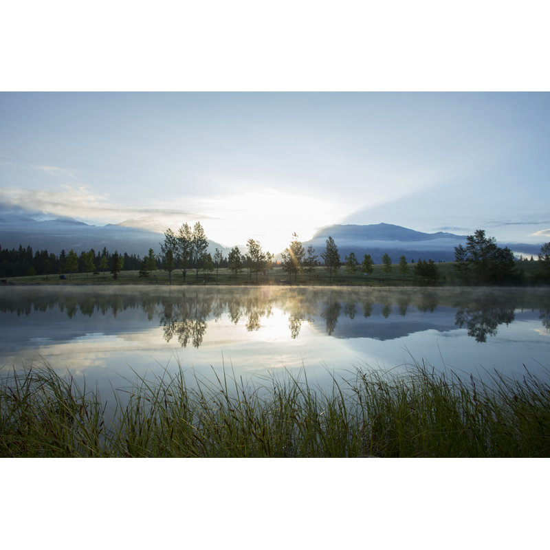 Perfect reflection of forest and mountains in lake at sunrise, 61cm H x 91cm W