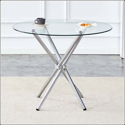 Table de salle à manger ronde en verre avec pieds argentés en forme d'anneau