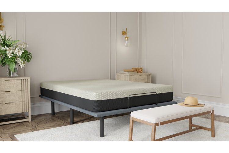 King size mattress on plain metal king-sized bed frame in large primary bedroom