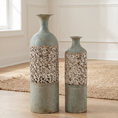 A set of rustic-style worn-metal vases