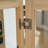 Lighted Glass Curio Display Cabinet with Adjustable Shelves, LED Lights, and Vintage Metal Handles for Elegant Storage