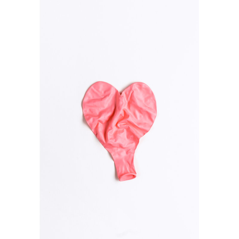 Deflated Wrinkled Pink Heart Shaped Balloon Laying Flat On White Background by Satamedia - Wrapped Canvas Print