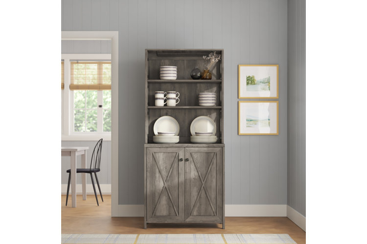 Weathered gray dining hutch with barn-style cabinets.