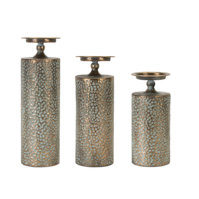 Ensemble de trois porte-bougies sur pied en métal