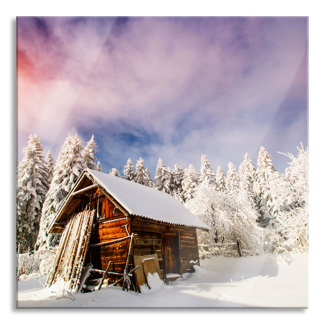 Glasbild Holzhütte im Schnee