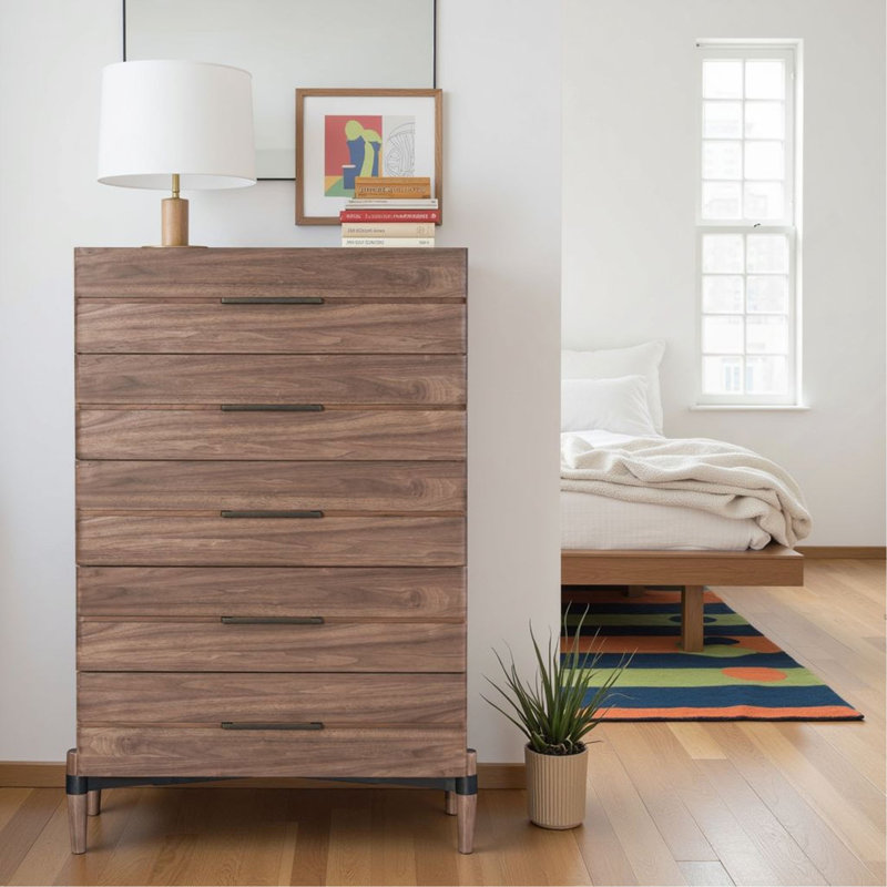 La commode et la commode avec une finition en bois clair et des poignées foncées minces allient simplicité moderne et rangement spacieux pour la chambre à coucher