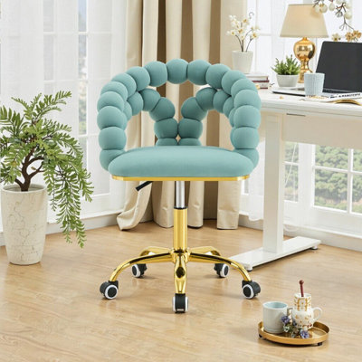 Fauteuil de bureau pivotant en velours avec dossier à bulles et base dorée