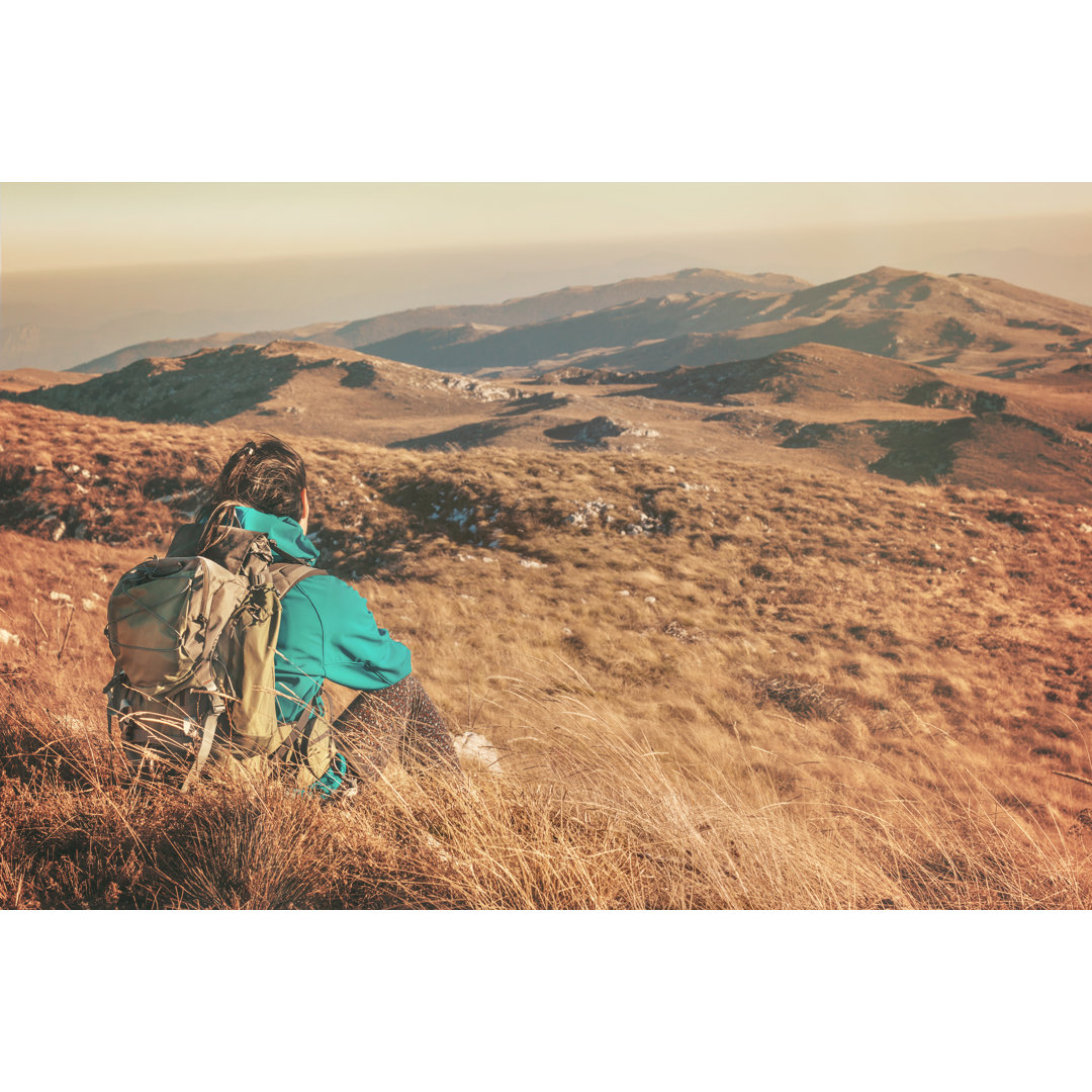 Girl Hiker Sitting In Beautiful Mountain von Danez - No Frame Kunstdrucke auf Leinwand