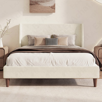 Lit plateforme tapissier moderne ivoire avec tête de lit à oreilles et pieds en bois de noyer