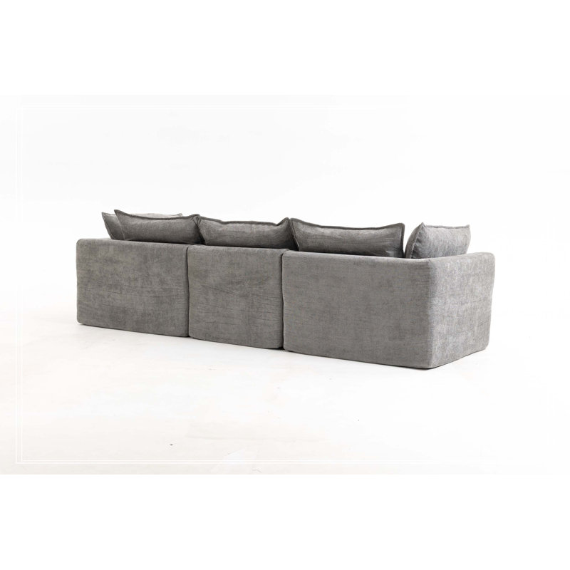 Canapé d'angle modulaire surdimensionné Cloud Couch de 260 cm de large, offrant un confort optimal et une assise large et profonde. Revêtement en tissu gaufré, 3 places avec pouf.