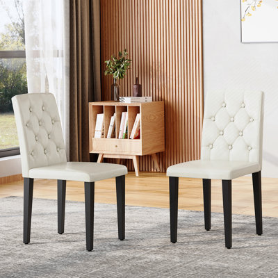 Ensemble de 2 chaises de salle à manger ergonomiques en polyuréthane avec dossier à boucle et pieds en métal robustes pour une assise confortable.