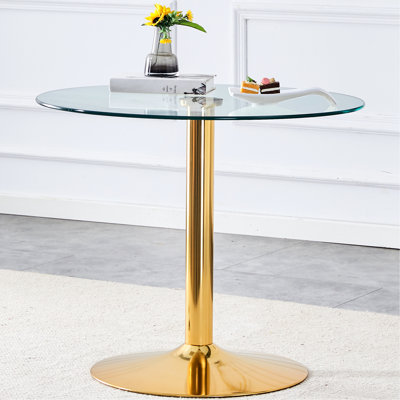 Table de salle à manger de style moderne avec pieds en métal doré et plateau en verre trempé de 35 po, qui rehausse l'ambiance de la pièce. Plateau et pieds lisses de 35 po de diamètre. Conception polyvalente