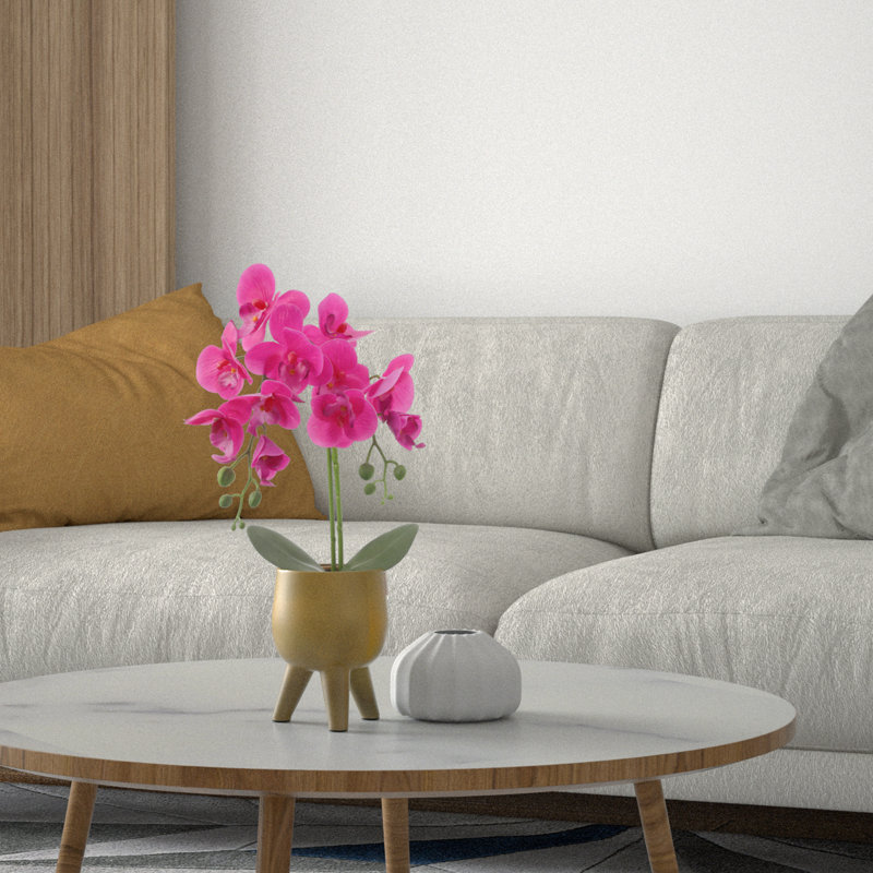 Orchidée rose dans un pot en cuivre