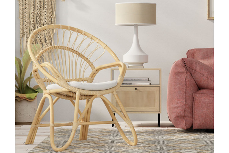 light wood boho-style papasan chair in a room with other boho decor and a white cushion