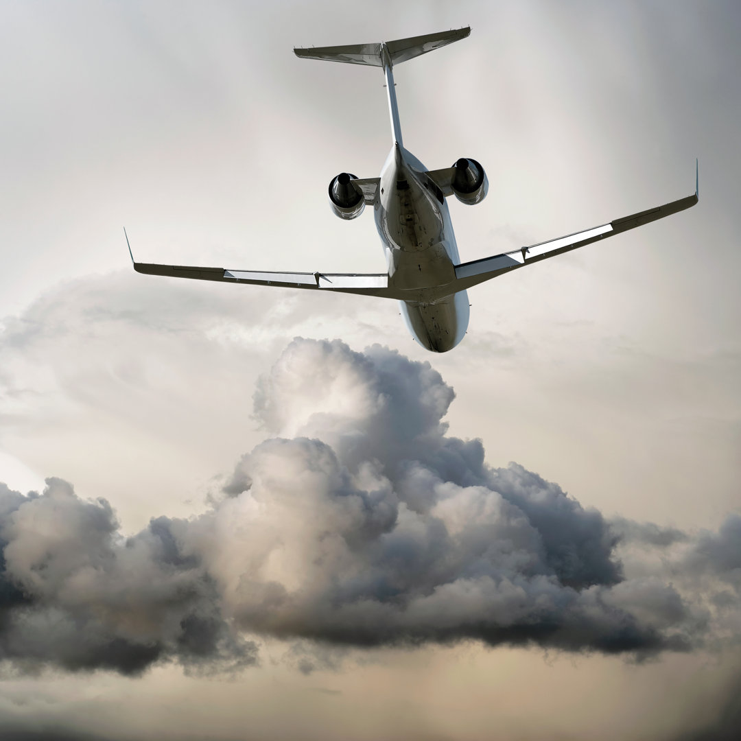 Corporate Jet Airplane Flying In Storm von Sharplydone - Leinwandbild