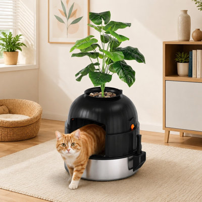 Ce bac à litière pour chat en acier inoxydable noir, dissimulé dans un style jardinière, comprend une pelle, un coussinet, un filtre à charbon et une fausse plante ; sa conception anti-odeurs et facile à nettoyer est idéale pour les salons, les chambres et les coins.