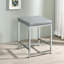 Tabouret de coiffeuse gris avec coussin carré rembourré en mousse et base en similicuir chic et contemporain