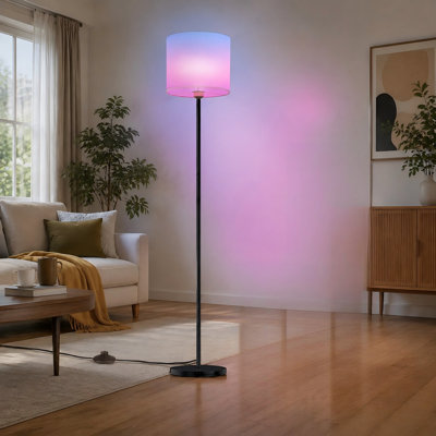 Tall smart LED floor lamp with a white linen shade, remote control, WiFi connectivity, color-changing output, and dimming; designed for bright lightin